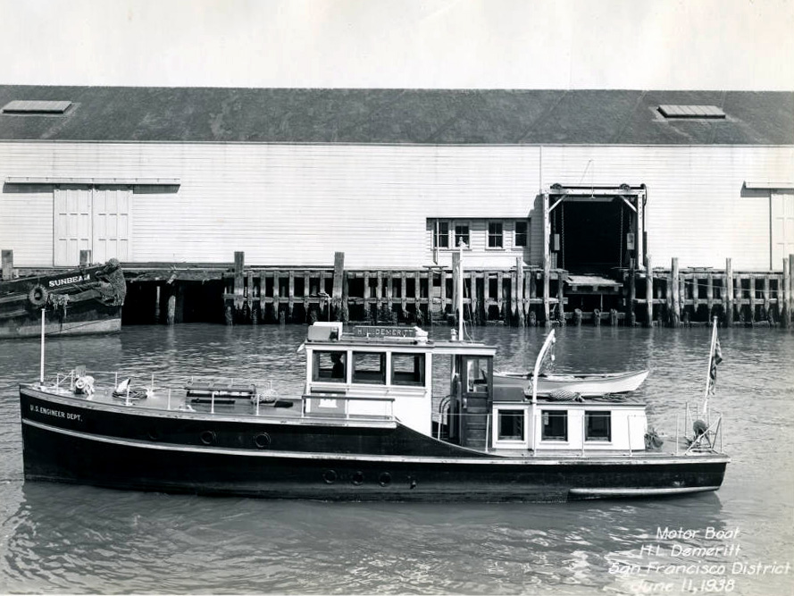 side view of boat in a body of water near facilities side view of boat in a body of water near facilities